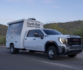 North Star Outdoor Lighting service trucks parked in the desert at dusk