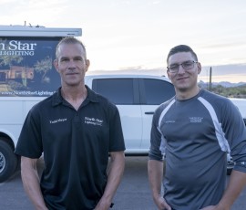 Todd Meyer with a North Star Outdoor Lighting technician in front of company trucks